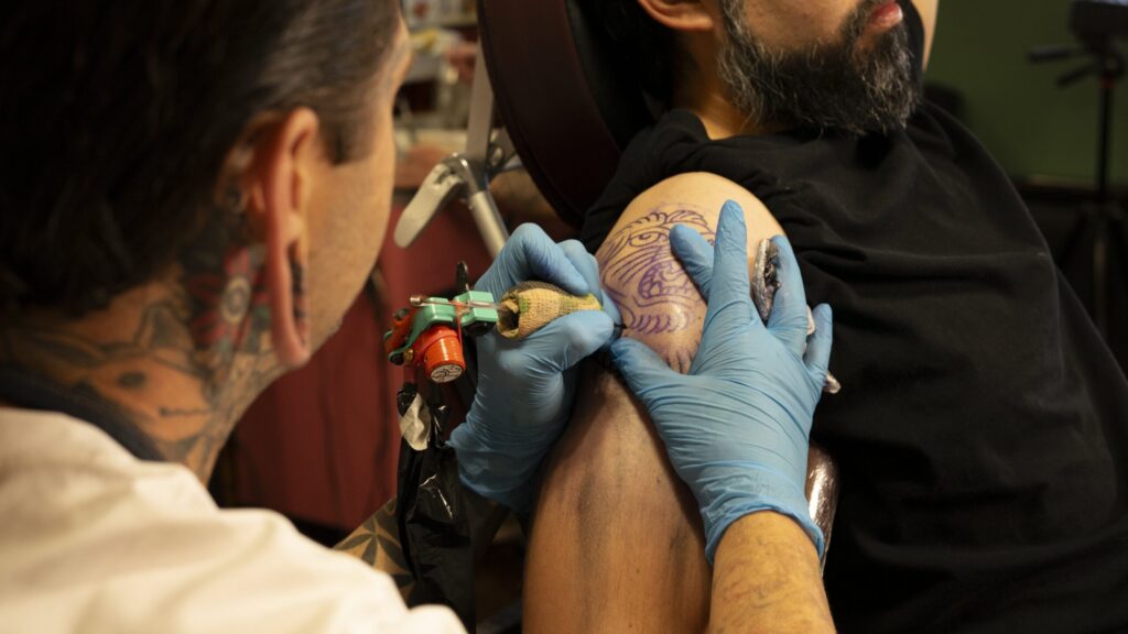 Wayne Fredrickson tattooing on a client